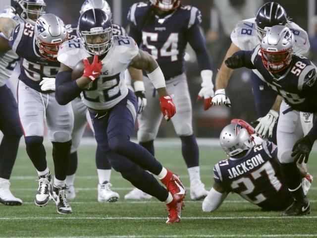 Tennessee Titans running back Derrick Henry runs from New England Patriots defenders in the first half of an NFL wild-card playoff football game, Saturday, Jan. 4, 2020, in Foxborough, Mass. (AP Photo/Charles Krupa)