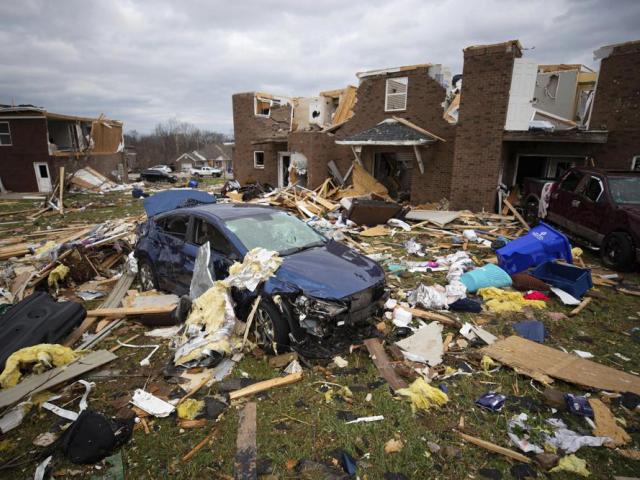 A car sits in the debris caused by a tornado in Bowling Green, Ky., Saturday, Dec. 11, 2021. (AP Photo/Michael Clubb)