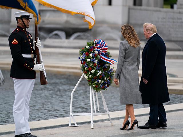 President Donald Trump and first lady Melania Trump participate in a wreath laying ceremony at the World War II Memorial to commemorate the 75th anniversary of Victory in Europe Day, Friday, May 8, 2020, in Washington. (AP Photo/Evan Vucci)
