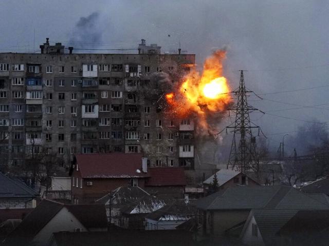 An explosion is seen in an apartment building after Russian&#039;s army tank fires in Mariupol, Ukraine, Friday, March 11, 2022. (AP Photo/Evgeniy Maloletka)