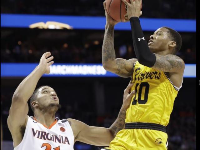 UMBC's Jarius Lyles (10) shoots over Virginia’s Isaiah Wilkins (21) during the second half of a first-round game in the NCAA men’s college basketball tournament. UMBC's Jarius Lyles (10) shoots over Virginia’s Isaiah Wilkins (21) during the second half of a first-round game in the NCAA men’s college basketball tournament.
