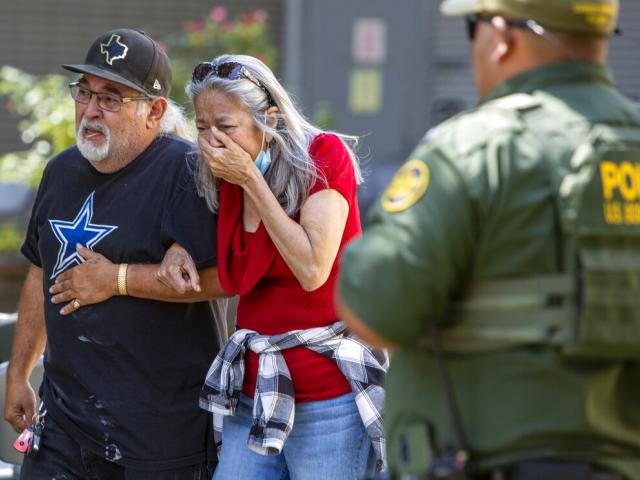 A woman cries as she leaves the Uvalde Civic Center, May 24, 2022, in Uvalde, Texas. An 18-year-old gunman opened fire at a Texas elementary school, killing 19 children and 2 teachers (William Luther/The San Antonio Express-News via AP)