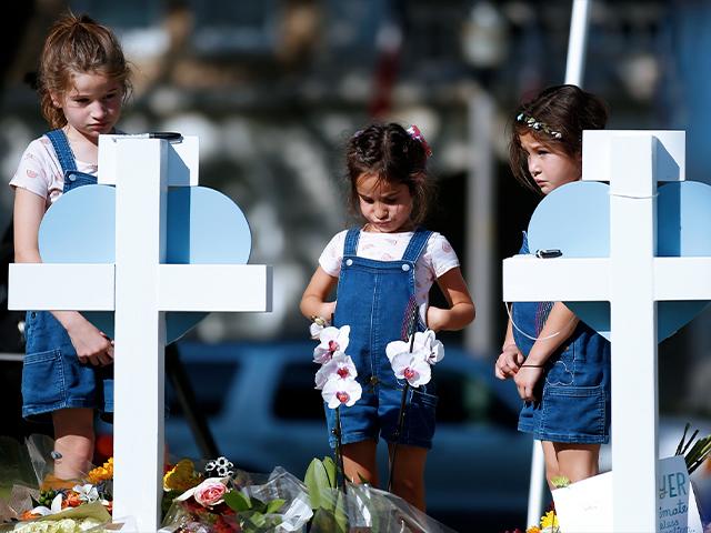 Children pay their respects at a memorial site for the victims killed in this week&#039;s elementary school shooting in Uvalde, Texas, Thursday, May 26, 2022. (AP Photo/Dario Lopez-Mills)