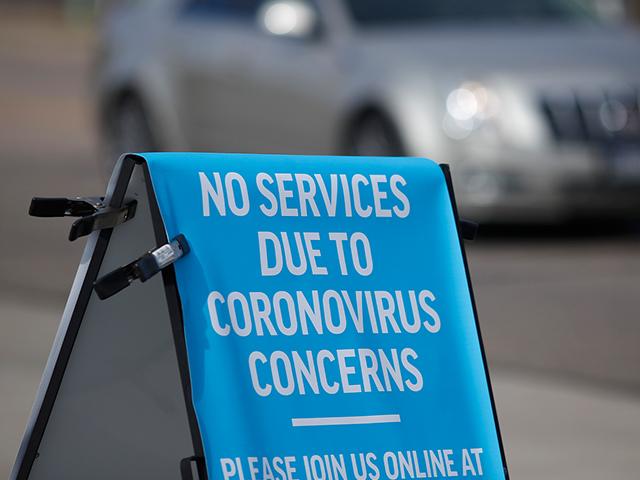 A sign stands outside a church to advise parishoners that services were cancelled because of the coronavirus pandemic Sunday, March 15, 2020, in Highlands Ranch, Colo. (AP Photo/David Zalubowski)