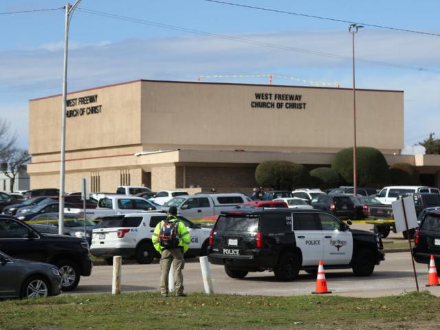 A person stands near the scene of a church shooting at West Freeway Church of Christ on Sunday, Dec. 29, 2019 in White Settlement, Texas. (Juan Figueroa/The Dallas Morning News via AP)