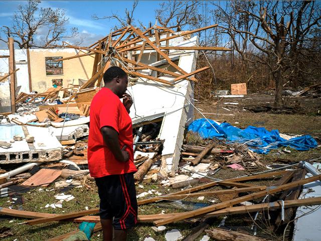 A man cries after discovering his shattered house and not knowing if his 8 relatives who lived in the house, survived Hurricane Dorian on Grand Bahama island (AP Photo/Ramon Espinosa)