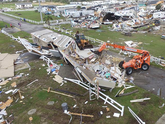 Emerald Isle town employees work to clear the road after a tornado hit Emerald Isle N.C. as Hurricane Dorian moved up the East coast on Thursday, Sept. 5, 2019. (AP Photo/Tom Copeland)