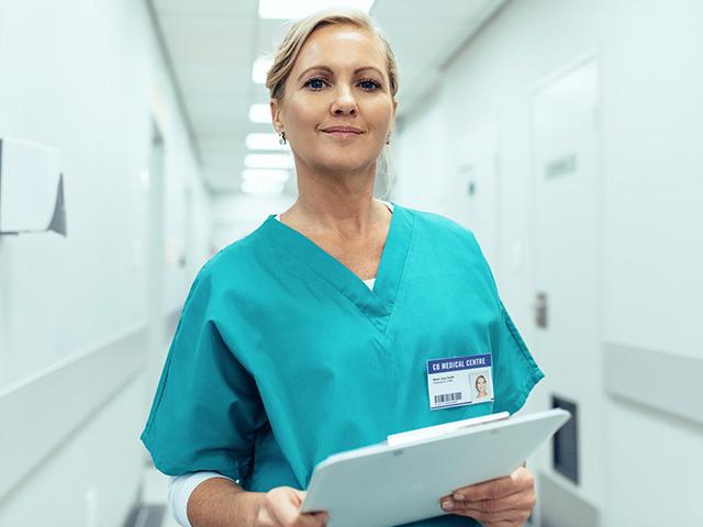 female nurse at hospital wearing scrubs