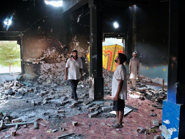 Christians stand inside a church building torched by an angry Muslim mob in Jaranwala near Faisalabad, Pakistan, Aug. 17, 2023. (AP Photo/K.M. Chaudary)