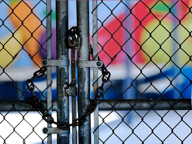 A chain-link fence lock is seen on a gate at a closed Ranchito Elementary School in the San Fernando Valley section of Los Angeles on July 13, 2020 (AP Photo/Richard Vogel)