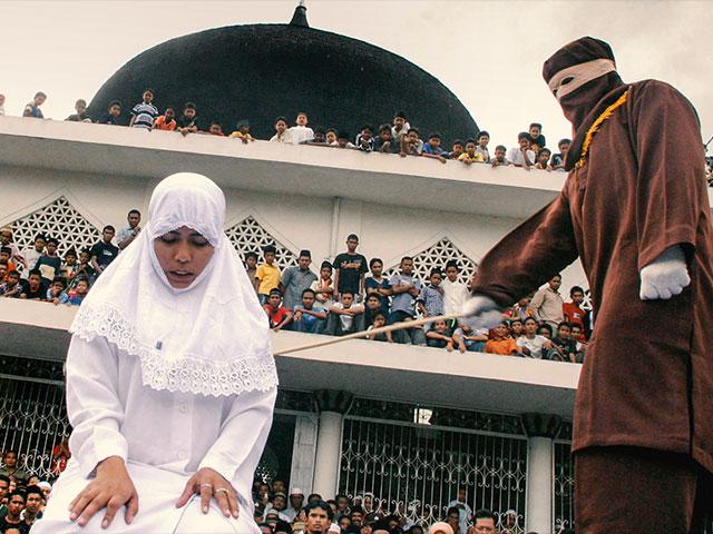 Shariah law officer canes a woman