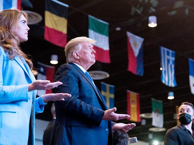 President Donald Trump closes his eyes as he accepts blessings as he attends church at International Church of Las Vegas, Sunday, Oct. 18, 2020, in Las Vegas, Nev. Counselor to the President Hope Hicks is at left. (AP Photo/Alex Brandon)