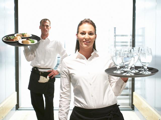 waitress and waiter carrying food and drinks