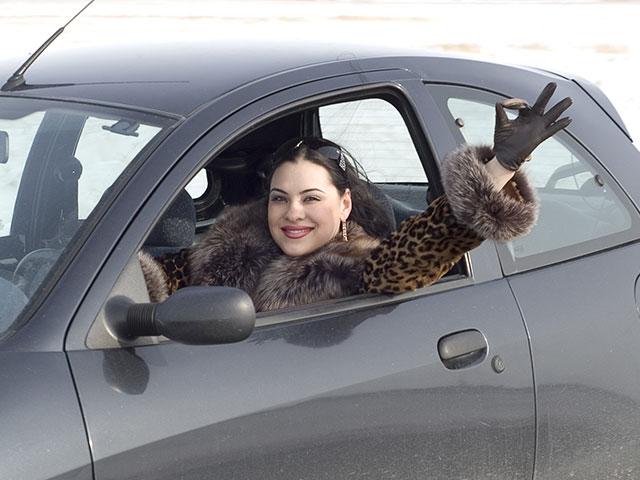 woman driving and giving okay hand signal