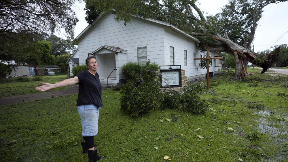 Ann McCauley examines the damage at Bethel Church after Hurricane Beryl moved through the area, Monday, July 8, 2024, in Van Vleck, Texas. (AP Photo/Eric Gay)