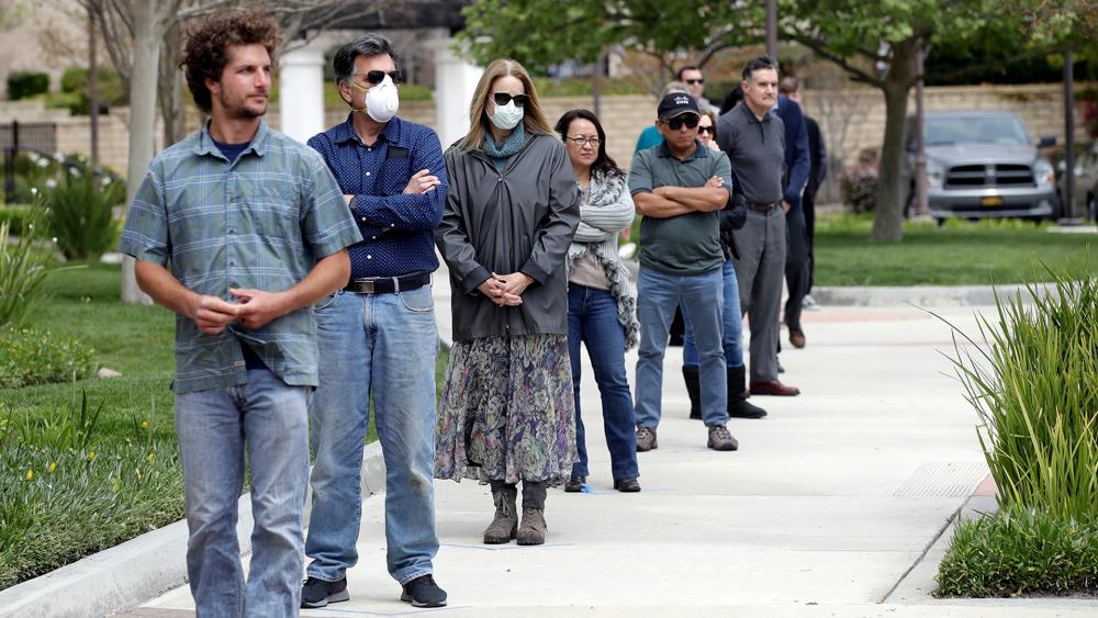 Worshippers practice social distancing as they line up to take communion outside of Godspeak Calvary Chapel, April 5, 2020, in Newbury Park, Calif. (AP Photo/Marcio Jose Sanchez)