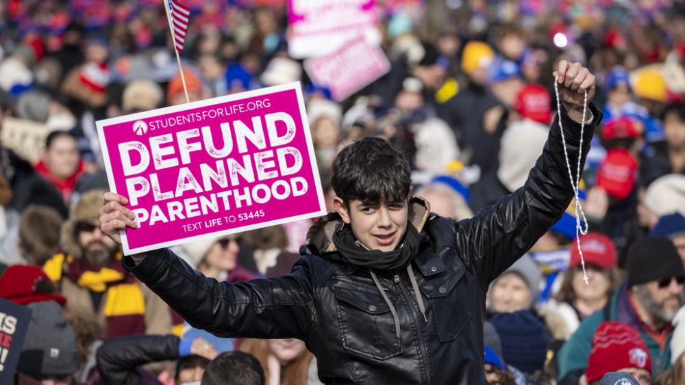 Young protestor raises a &quot;Defund Planned Parenthood&quot; sign during the 52nd annual March for Life on the National Mall in Washington on Jan. 24, 2025. (Angelina Katsanis/POLITICO via AP Images)