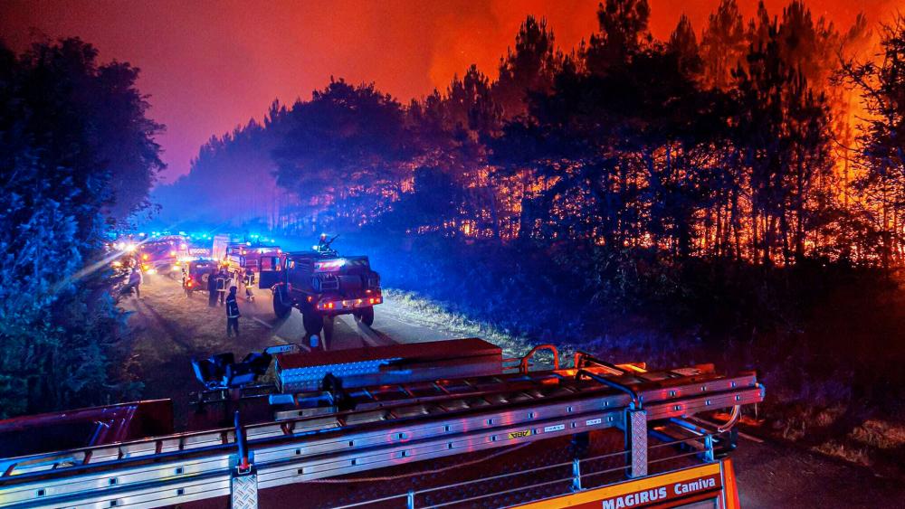 Firefighters battled wildfires raging out of control in France and Spain on Sunday as Europe wilted under an unusually extreme heat wave that authorities in Madrid blamed for hundreds of deaths. (SDIS 33 via AP)