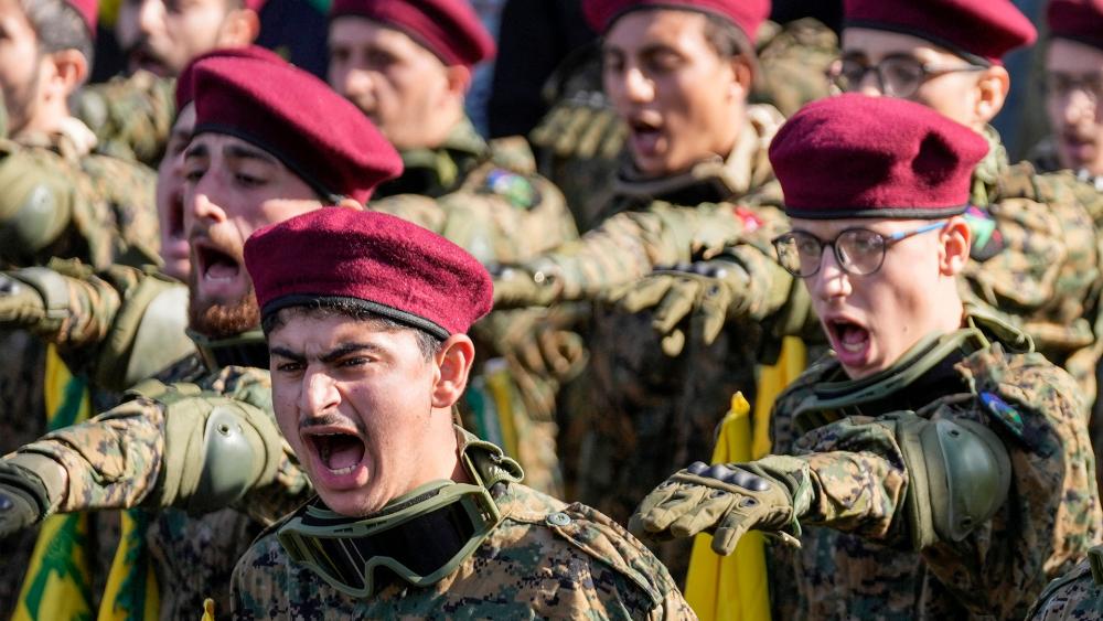 Hezbollah fighters chant slogans as they attend the funeral procession of senior Hezbollah commander Wissam Tawil, during his funeral procession in the village of Khirbet Selm, south Lebanon, Tuesday, Jan. 9, 2024. (AP Photo/Hussein Malla)