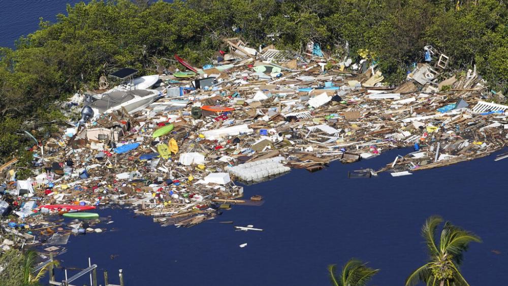 Debris is piled up at the end of a cove following heavy winds and storm surge caused by Hurricane Ian Thursday, Sept. 29, 2022, in Barefoot Beach, Fla. (AP Photo/Marta Lavandier)