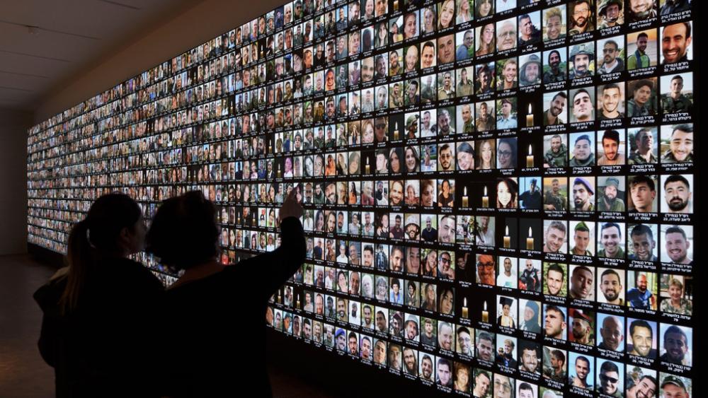 Photos of Israeli people who were murdered by Hamas terrorists on Oct. 7, displayed on a giant screen at the National Library in Jerusalem, Israel, Jan. 28, 2024. (AP Photo/Leo Correa)
