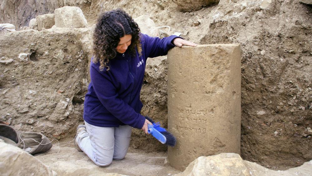 IAA archaeologist Danit Levy examines the 2,000 year-old inscription of &#039;Jerusalem&#039;, Photo, IAA, Yoli Shwartz