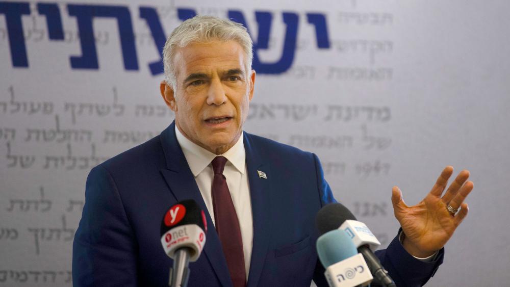 Yesh Atid party leader Yair Lapid speaks to journalists at the Knesset, Israel&#039;s Parliament, Monday, June 7, 2021. (AP Photo/Maya Alleruzzo, Pool)