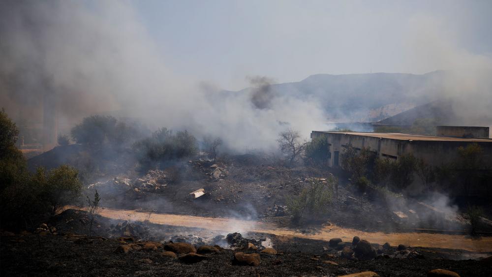 Fields burn following a hit by a rocket fired from Lebanon into Israeli territory, near the northern Israeli town of Kiryat Shmona, Wednesday, Aug. 4, 2021. (AP Photo/Ariel Schalit)