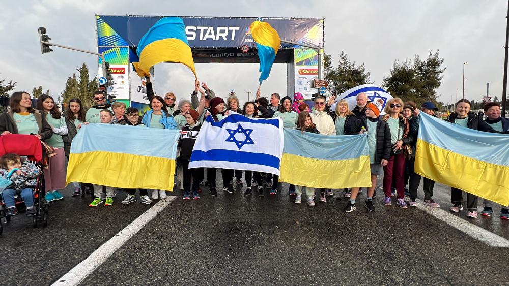 Runners holding Ukraine and Israeli flags at the Jerusalem Winner Marathon 2022. Photo Credit: CBN News
