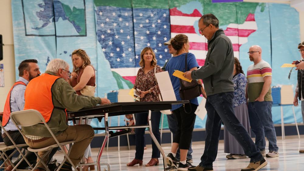 People line up to vote in front of a mural at a Elementary school polling station Tuesday Nov. 7, 2023, in Midlothian, Va. (AP Photo/Steve Helber)