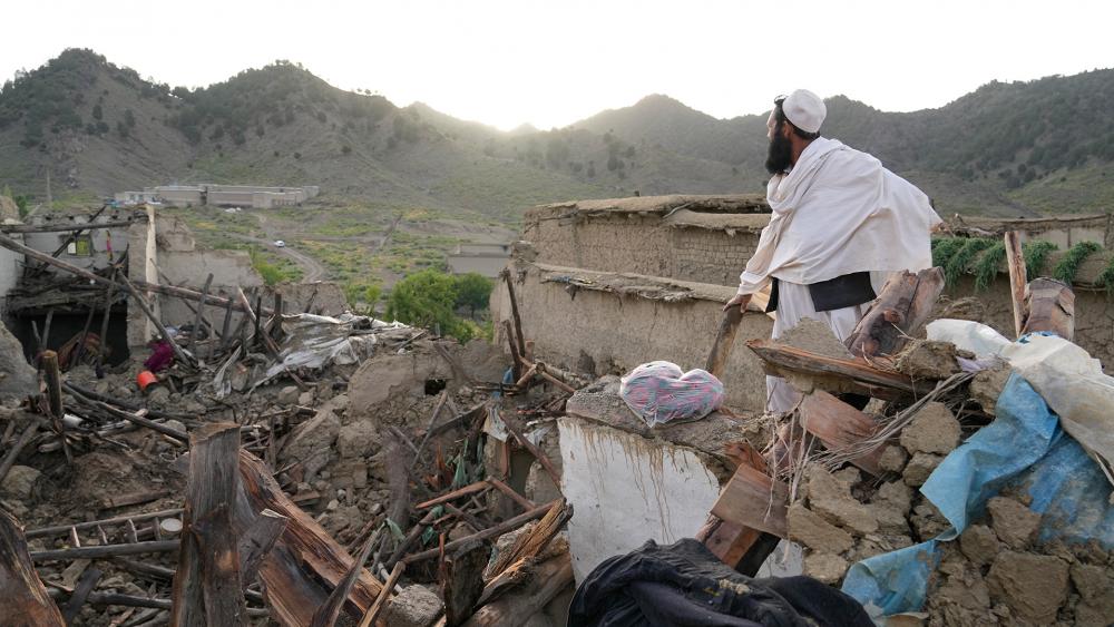 A man stands among destruction after an earthquake in Gayan village, in Paktika province, Afghanistan, Thursday, June 23, 2022. (AP Photo/Ebrahim Nooroozi)