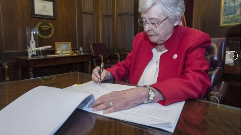 This photograph released by the state shows Alabama Gov. Kay Ivey signing a bill that virtually outlaws abortion in the state on Wednesday, May 15, 2019, in Montgomery, Ala. (Hal Yeager/Alabama Governor&#039;s Office via AP) 