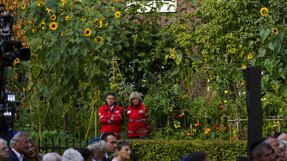 Rescue workers watch a ceremony where King Willem-Alexander officially unveiled a new monument in the heart of Amsterdam&#039;s historic Jewish Quarter on Sunday, Sept. 19, 2021, honoring the 102,000 Dutch victims of the Holocaust. (AP Photo/Peter Dejong)