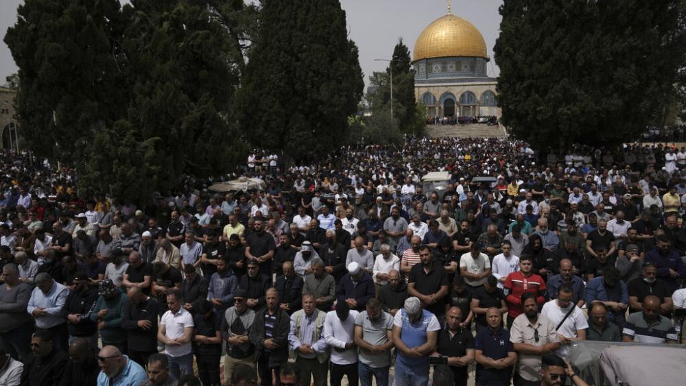 Palestinians pray during holy Islamic month of Ramadan in front of the Dome of the Rock shrine in Jerusalem, Friday, April 8, 2022. (AP Photo/Mahmoud Illean)