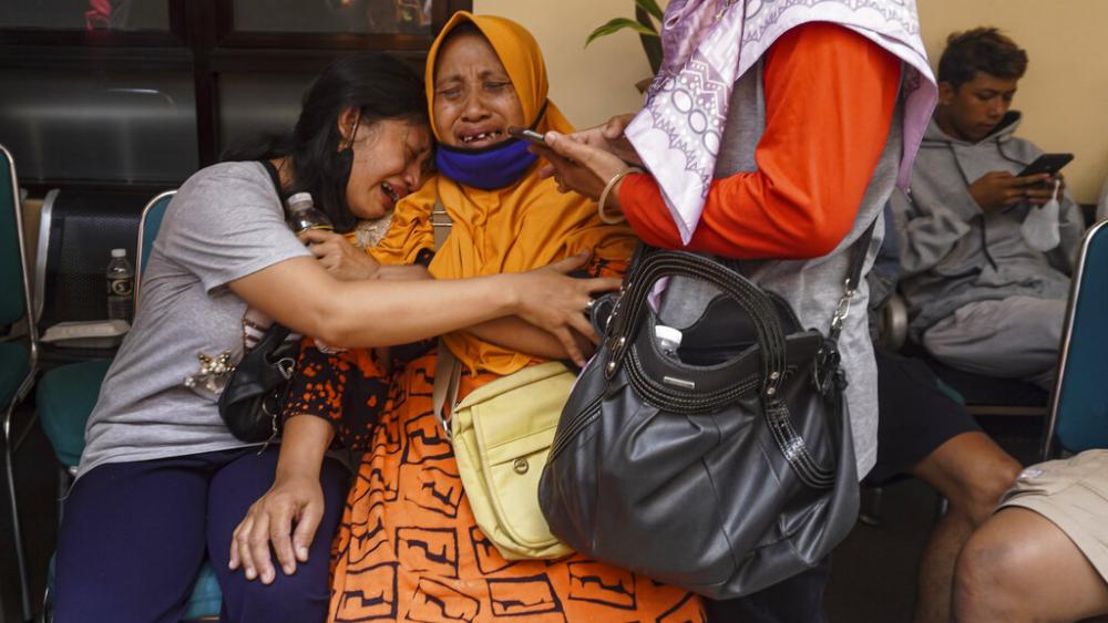 Women weep after receiving confirmation that their family member is among those killed in a soccer match stampede at a hospital in Malang, East Java, Indonesia, Sund ay, Oct. 2, 2022 (AP).