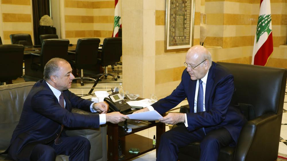 Lebanese Prime Minister Najib Makati, right, receives the final draft of the maritime border agreement between Lebanon and Israel from his deputy Elias Bou Saab. (Dalati Nohra via AP)