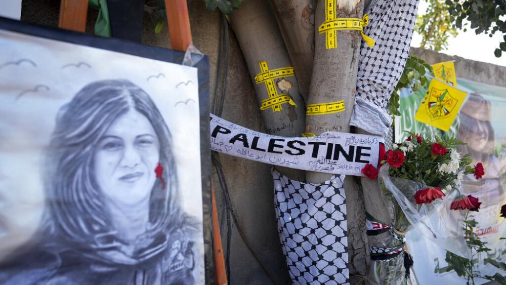 A portrait and flowers create a makeshift memorial, at the site where Palestinian-American Al-Jazeera journalist Shireen Abu Akleh was shot and killed in the West Bank city of Jenin, May 19, 2022. (AP Photo/Majdi Mohammed, File)