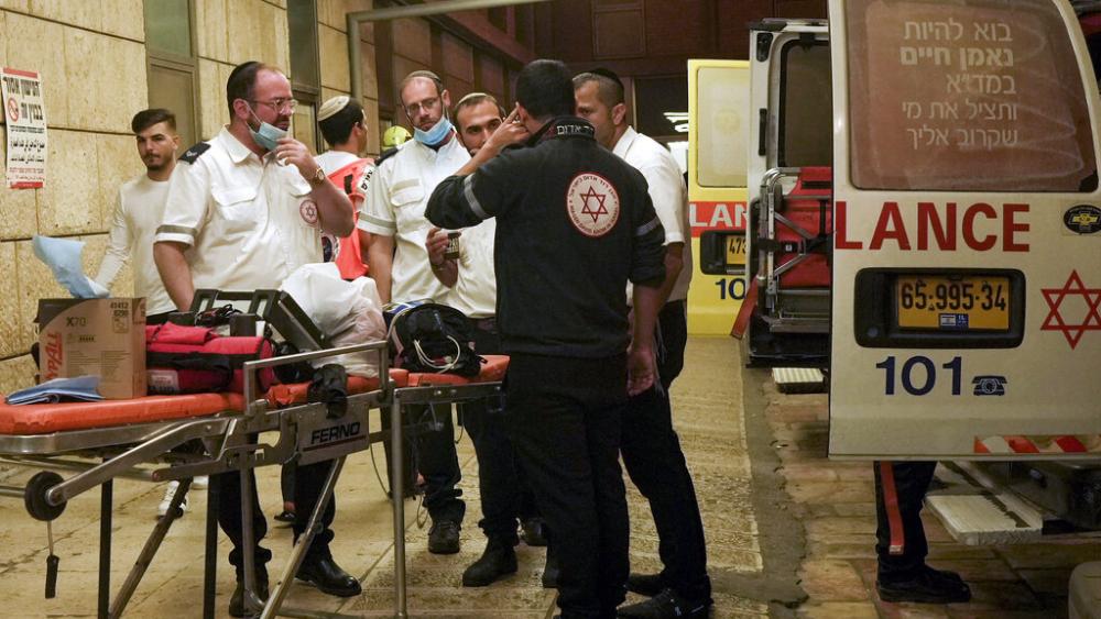 Paramedics gather at a hospital in Jerusalem on Saturday, Oct. 29, 2022, after they evacuated wounded form a shooting attack. (AP Photo/Mahmoud Illean)