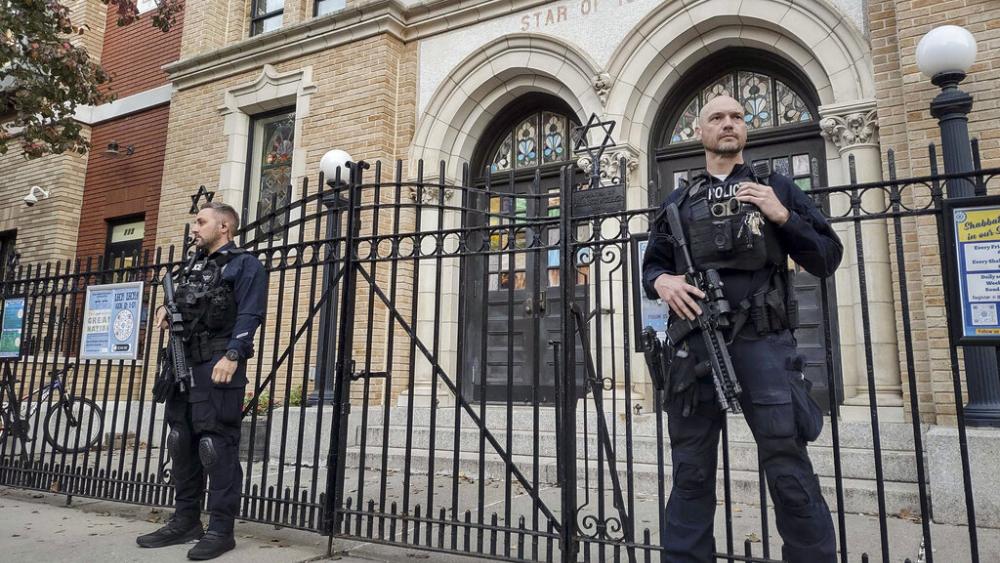 Hoboken Police officers stand watch outside the United Synagogue of Hoboken, Thursday, Nov. 3, 2022, in Hoboken, N.J. (AP Photo/Ryan Kryska)