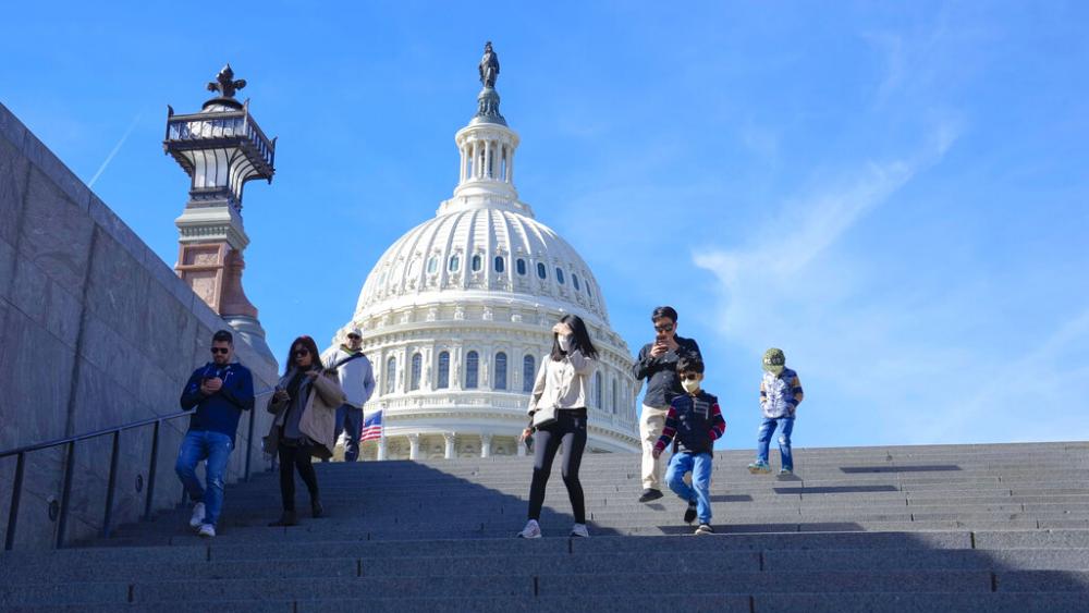 With the U.S Capitol in the background, people walk down steps on Election Day in Washington, Tuesday, Nov. 8, 2022. (AP Photo/Mariam Zuhaib)