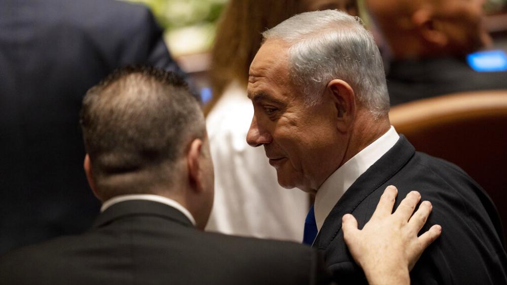Israel's incoming Prime Minister Benjamin Netanyahu speaks with a colleague at the swearing-in ceremony for Israel's parliament, at the Knesset, in Jerusalem, Tuesday, Nov. 15, 2022. (AP Photo/ Maya Alleruzzo, Pool)