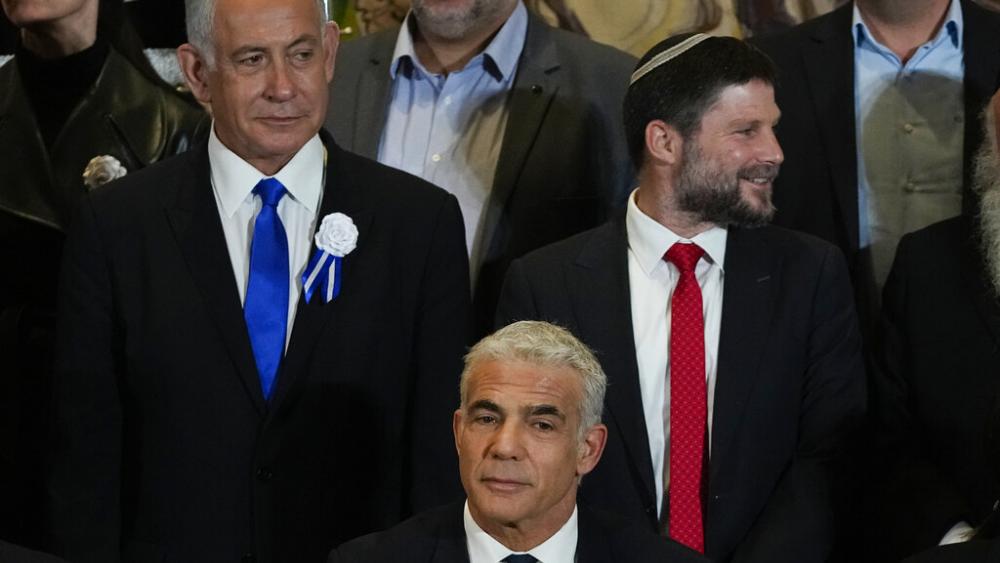 Israeli Prime Minister Yair Lapid, center, Likud Party leader Benjamin Netanyahu, left, and Israeli lawmaker Bezalel Smotrich at Knesset Nov. 15, 2022 (AP Photo/Tsafrir Abayov)