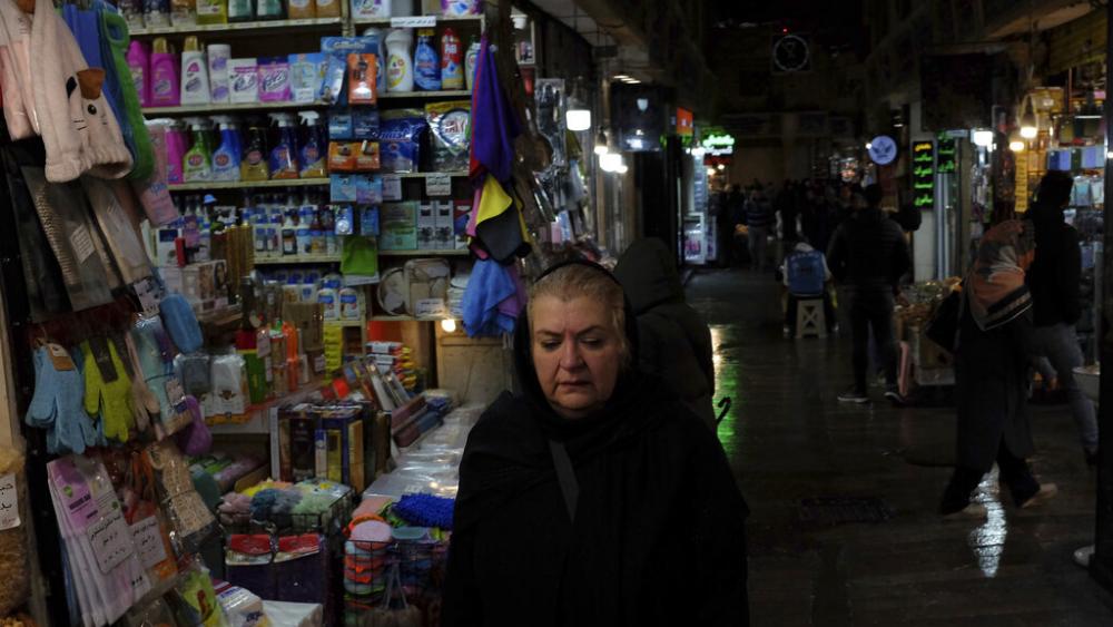 A woman walks through Tajrish bazaar in northern Tehran, Iran, Monday, Dec. 5, 2022. Confusion over the status of Iran’s religious police grew as state media cast doubt on reports the force had been shut down. (AP Photo/Vahid Salemi)
