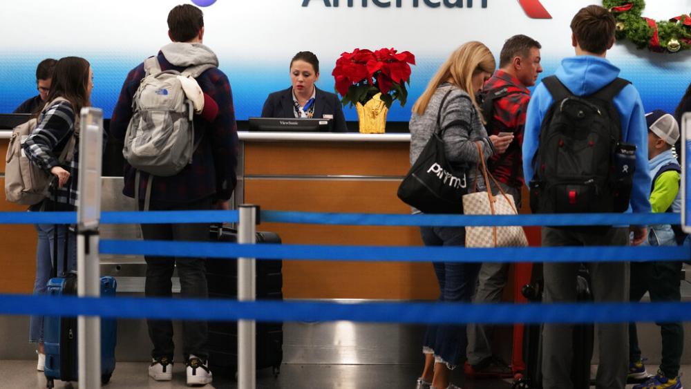 Travelers check in at an airline ticket counter in Chicago, Wednesday, Nov. 23, 2022. The Federal Reserve is set to raise its benchmark short-term rate on Wednesday, Dec. 14, for a seventh time this year. (AP Photo/Nam Y. Hu, file)