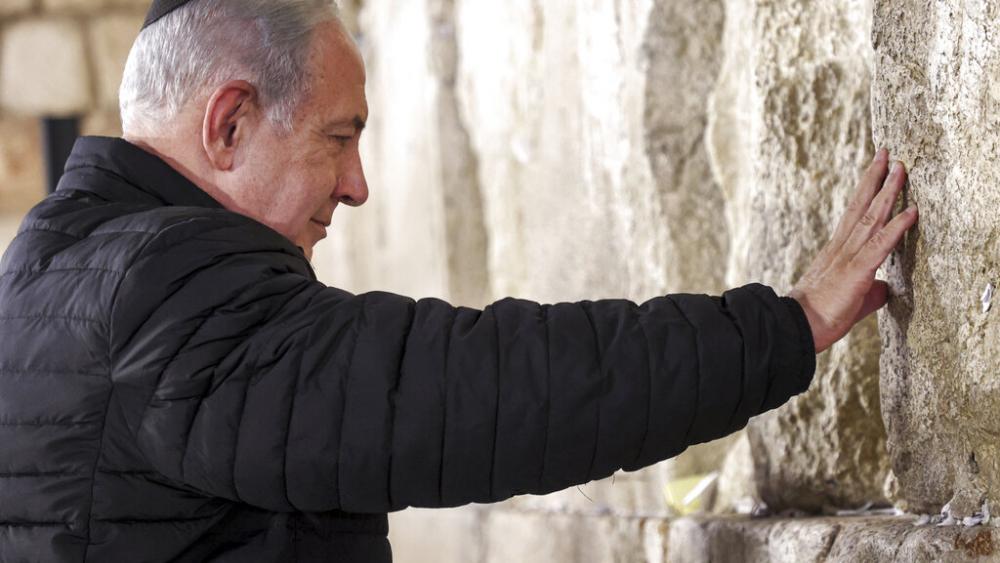Israel's Prime Minister Benjamin Netanyahu prays as he visits the Western Wall in the old city of Jerusalem on Sunday, Jan. 1, 2023. (Gil Cohen-Magen/Pool via AP)