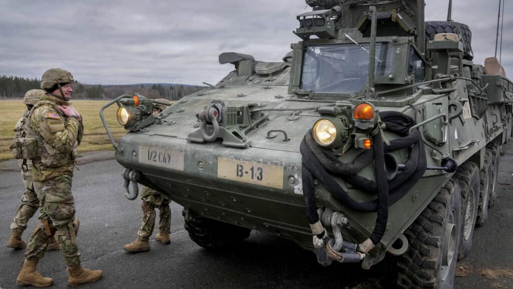  Soldiers of the 2nd Cavalry Regiment stand next to a Stryker combat vehicle in Vilseck, Germany, Wednesday, Feb. 9, 2022. (AP Photo/Michael Probst, File)