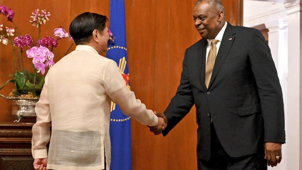 U.S. Secretary of Defense Lloyd James Austin III, right, shakes hands with Philippine President Ferdinand Marcos Jr. during a courtesy call at the Malacanang Palace in Manila, Philippines on Thursday, Feb. 2, 2023. (Jam Sta Rosa/Pool Photo via AP)