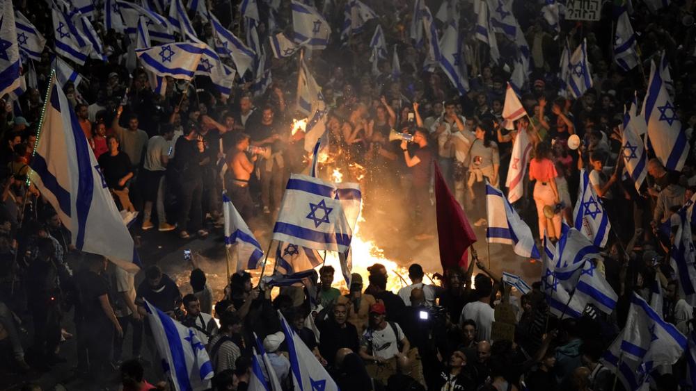 Protesters in Tel Aviv blocked a main highway Sunday, while police scuffled with protesters outside Netanyahu’s private home in Jerusalem. The unrest deepened a crisis over Netanyahu’s plan to overhaul the judiciary.  (AP Photo/Ohad Zwigenberg)