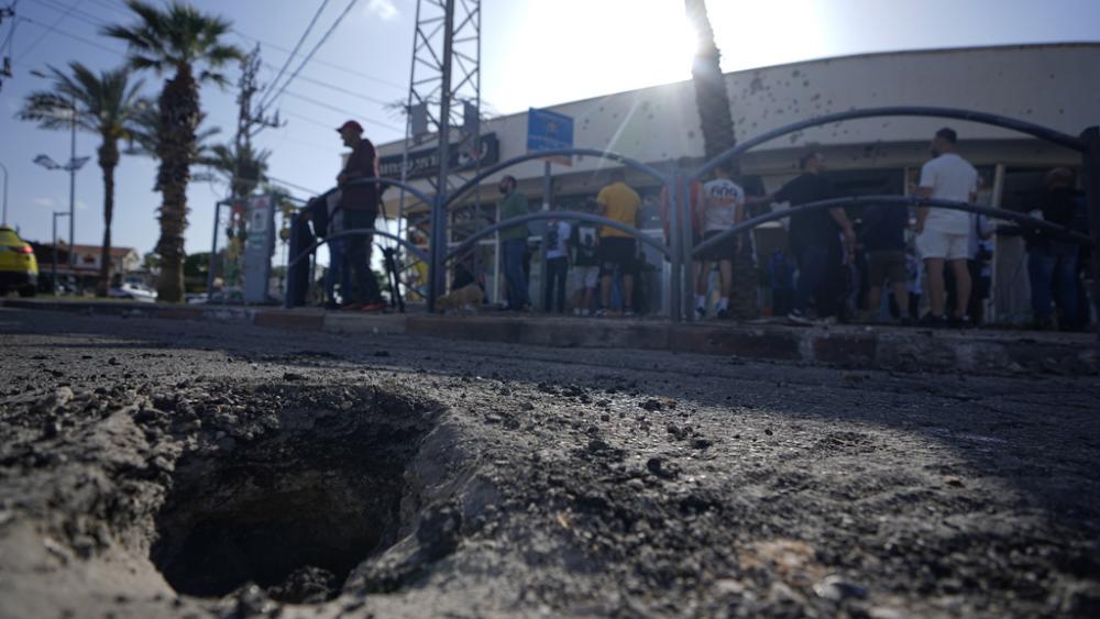 The crater from an intercepted rocket fired from Lebanon that landed in Shlomi, northern Israel Thursday, April 6, 2023. Israeli air defenses intercepted a rocket fired from Lebanon into northern Israel, the Israeli military said. (AP Photo/Ariel Schalit)