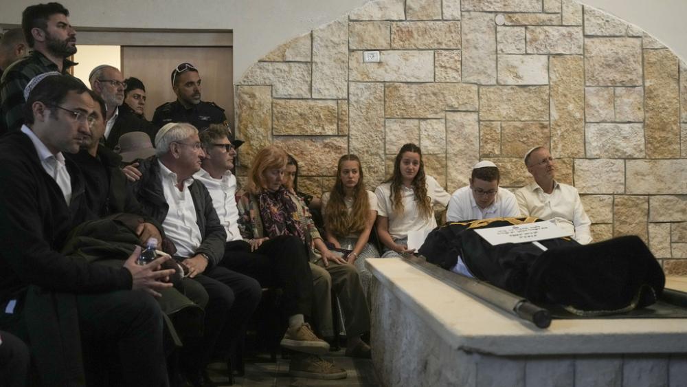 Husband and children of Lucy Dee mourn during her funeral at a cemetery in the West Bank settlement of Kfar Etzion, Tuesday, April 11, 2023. (AP Photo/Maya Alleruzzo)